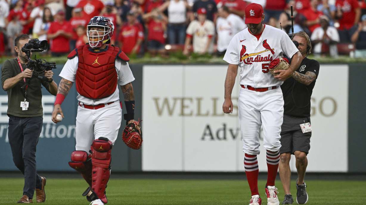 St. Louis Cardinals' Yadier Molina, left, and Adam Wainwright walk in from the bullpen after warming up for the team's baseball game against the Milwaukee Brewers on Wednesday Sept. 14, 2022, in St. Louis.