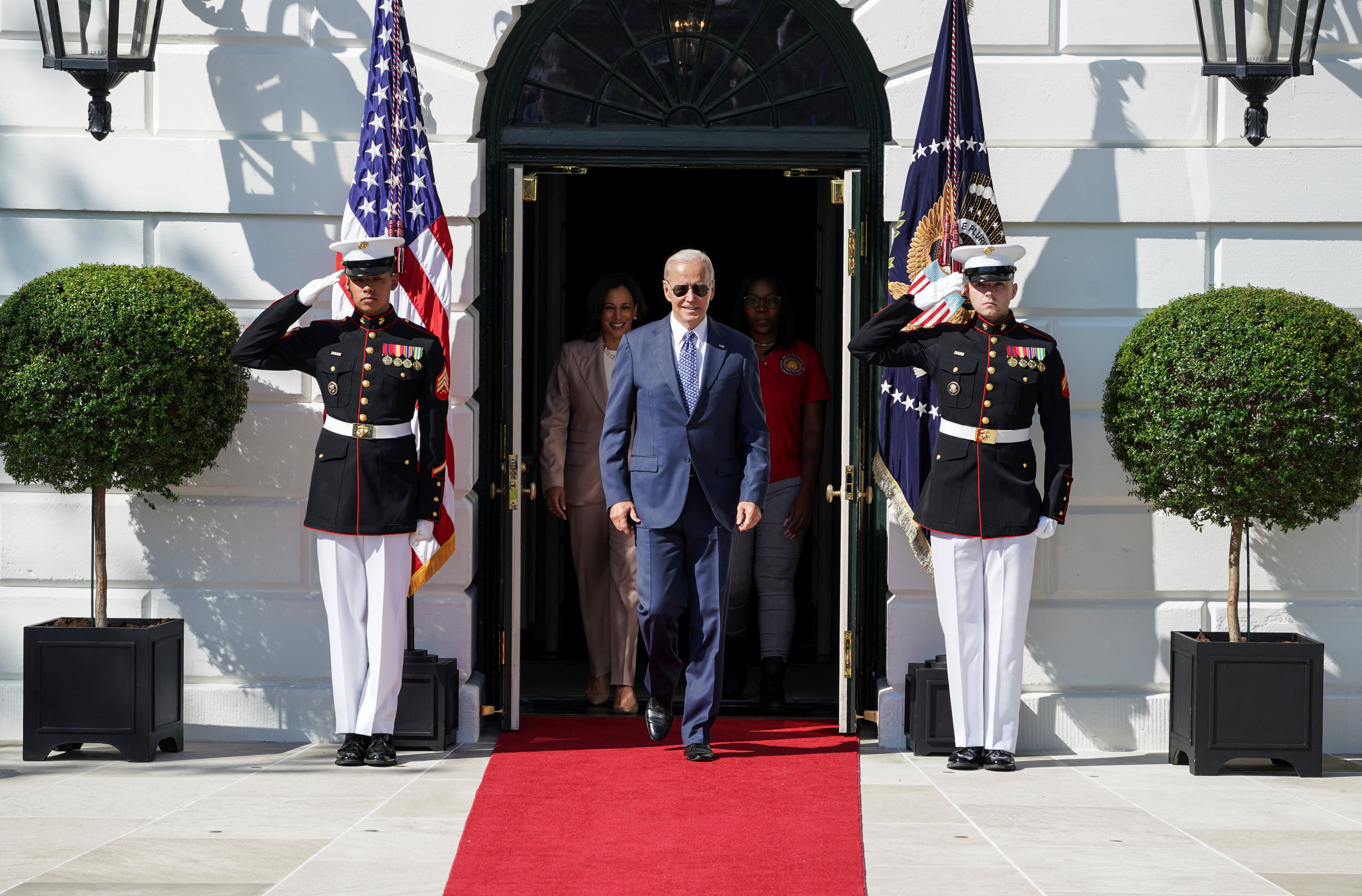 U.S. President Joe Biden, followed by U.S. Vice President Kamala Harris, arrives to celebrate the enactment of the "Inflation Reduction Act of 2022," which Biden signed into law in August, on the South Lawn at the White House in Washington, U.S., Wednesday. Biden's popularity improved substantially from his lowest point this summer.