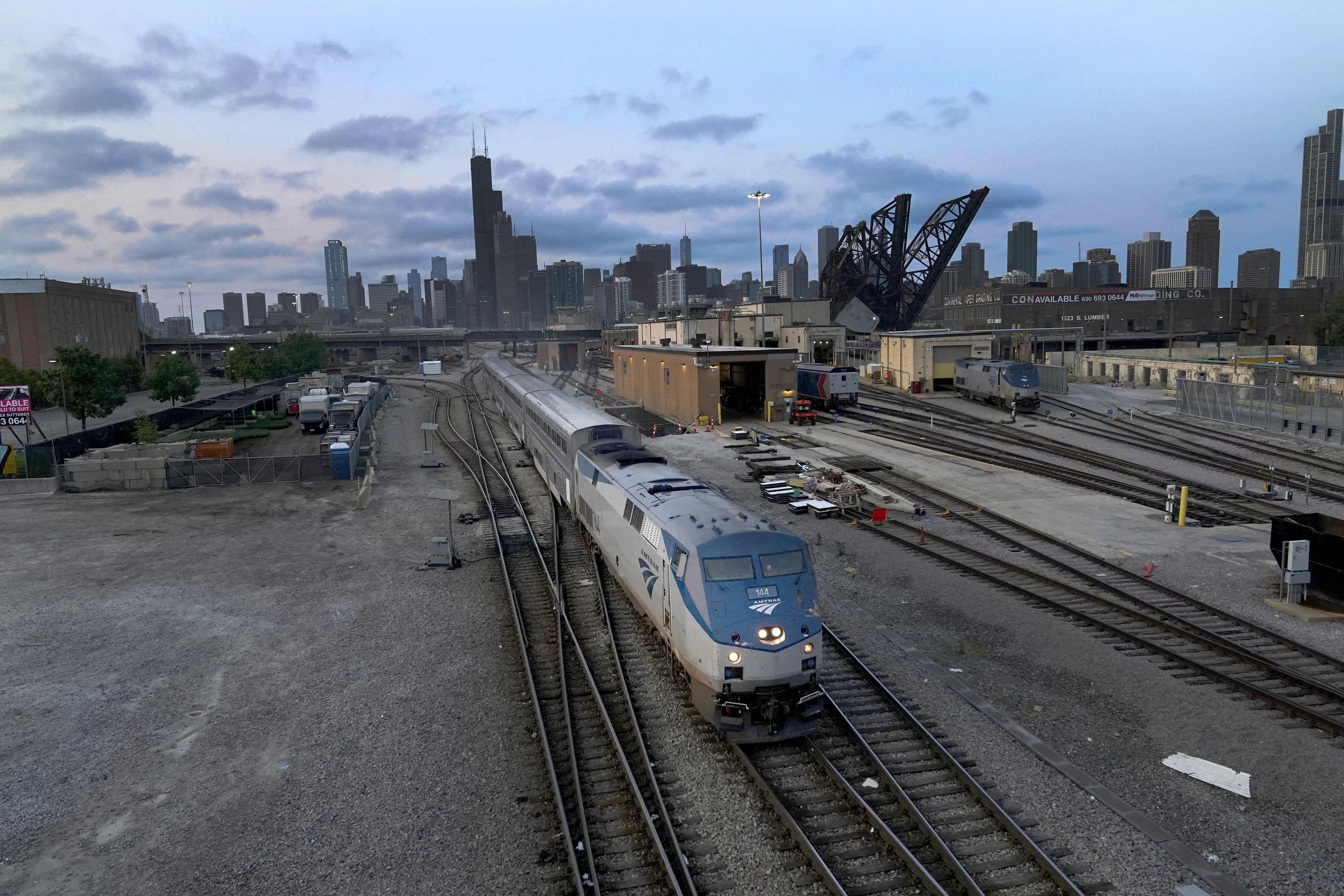 An Amtrak passenger train departs Chicago in the early evening headed south Wednesday in Chicago. President Joe Biden said Thursday that a tentative railway labor agreement has been reached, averting a potentially devastating strike before the pivotal midterm elections.