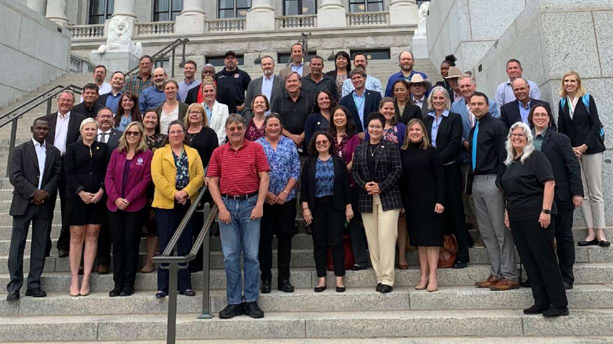 Members of the Wildland Fire Mitigation and Management Commission pose for a photo on the steps of the Utah State Capitol. The newly assembled group met for the first time in Salt Lake City on Wednesday for a two-day conference that wrapped up on Thursday.