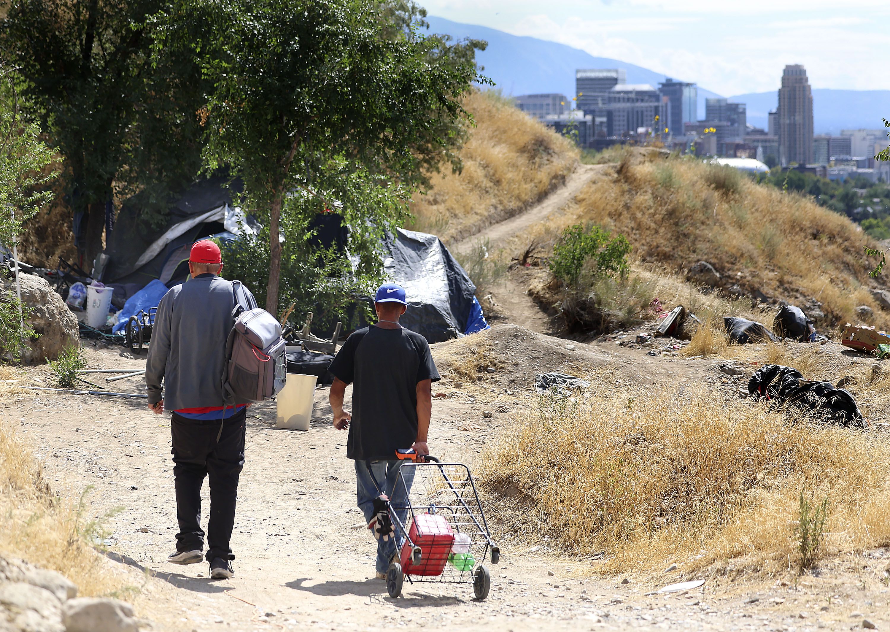 Alex, left, and Jason Brown return to Brown’s homeless camp above Victory Road in Salt Lake City on Thursday. Over the past week, there's been a lot of movement to pump tens of millions of dollars — including $55 million at the state level and $6 million from Salt Lake City — toward funding affordable housing and homelessness projects across the state of Utah. 