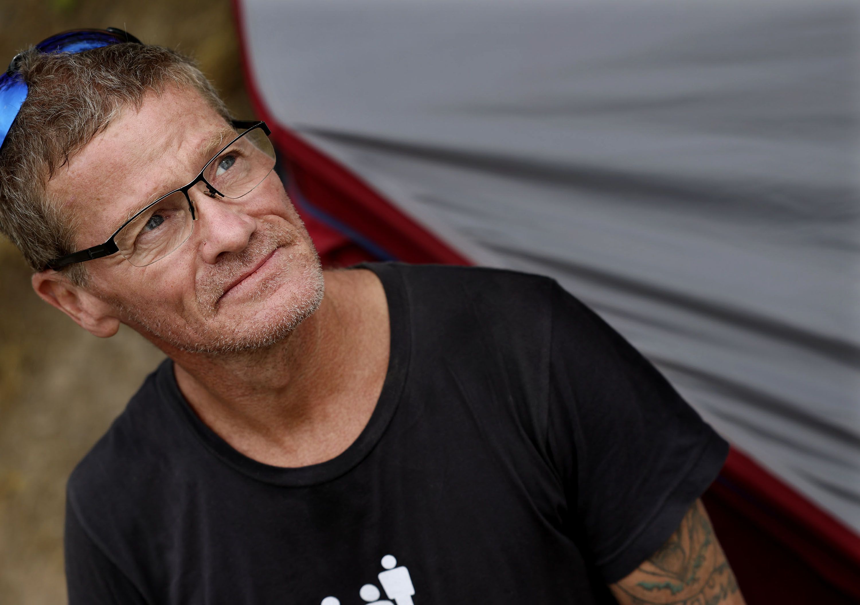 Kevin Hicks, 55, who is homeless, speaks to members of Salt Lake City’s Homeless Engagement and Response team at Hicks’ camp near Victory Road in Salt Lake City on Thursday. Hicks said he has been homeless for a few months since he lost his job and his was car stolen with his driver’s license inside. Hicks has been waiting for weeks to receive a new ID so that he can find a job. Hicks says he is “homeless not helpless.”