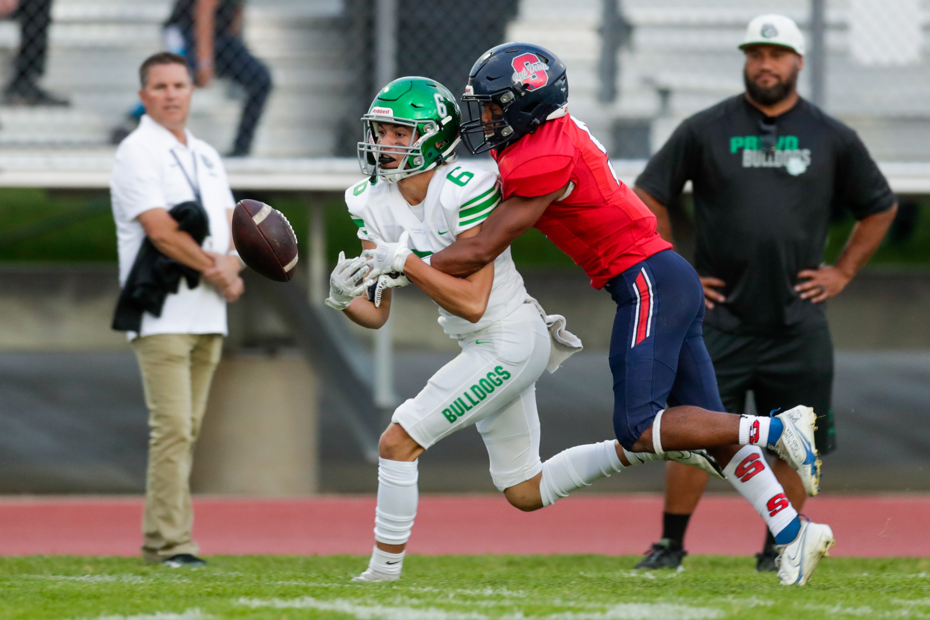 Drew Deucher (6) of the Provo Bulldogs misses a catch while be defended by Jaden Toki (9) of the Springville Red Devils in Springville on Thursday, Sept. 15, 2022. The Red Devils won 18-14.