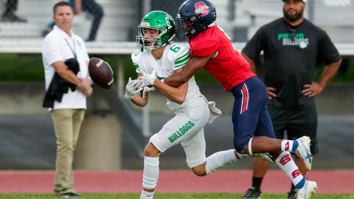 Drew Deucher (6) of the Provo Bulldogs misses a catch while be defended by Jaden Toki (9) of the Springville Red Devils in Springville on Thursday, Sept. 15, 2022. The Red Devils won 18-14.