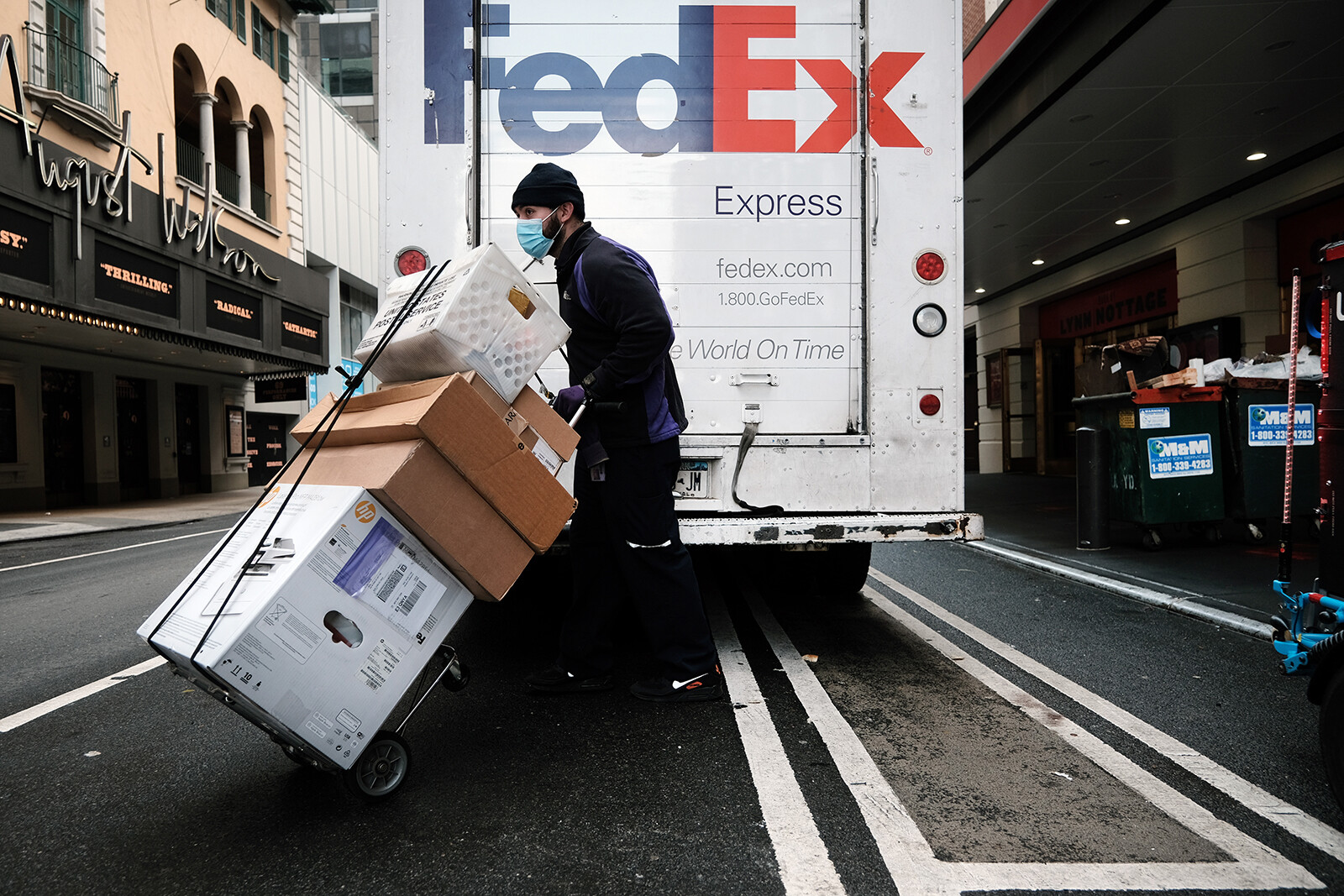 A FedEx truck is pictured here making deliveries on Dec. 6 in New York City. FedEx shares plunged 21% in premarket trading Friday after it warned that a slowing economy will cause it to fall $500 million short of its revenue target. 