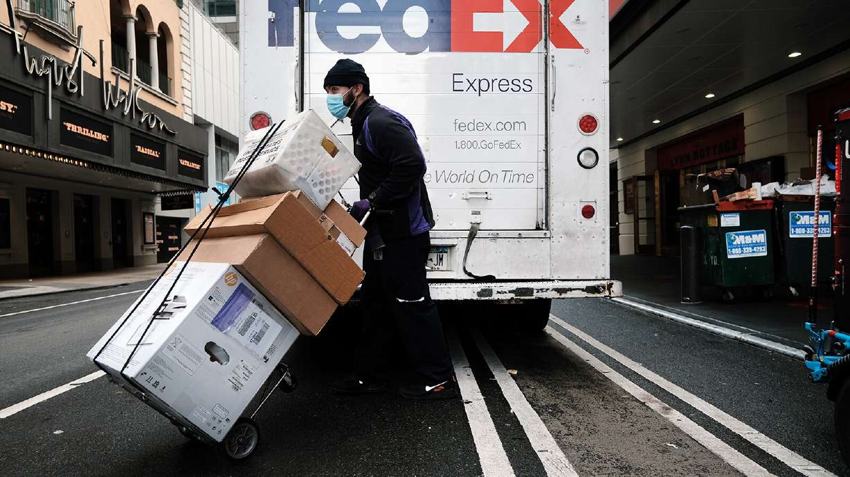 A FedEx truck is pictured here making deliveries on Dec. 6 in New York City. FedEx shares plunged 21% in premarket trading Friday after it warned that a slowing economy will cause it to fall $500 million short of its revenue target.
