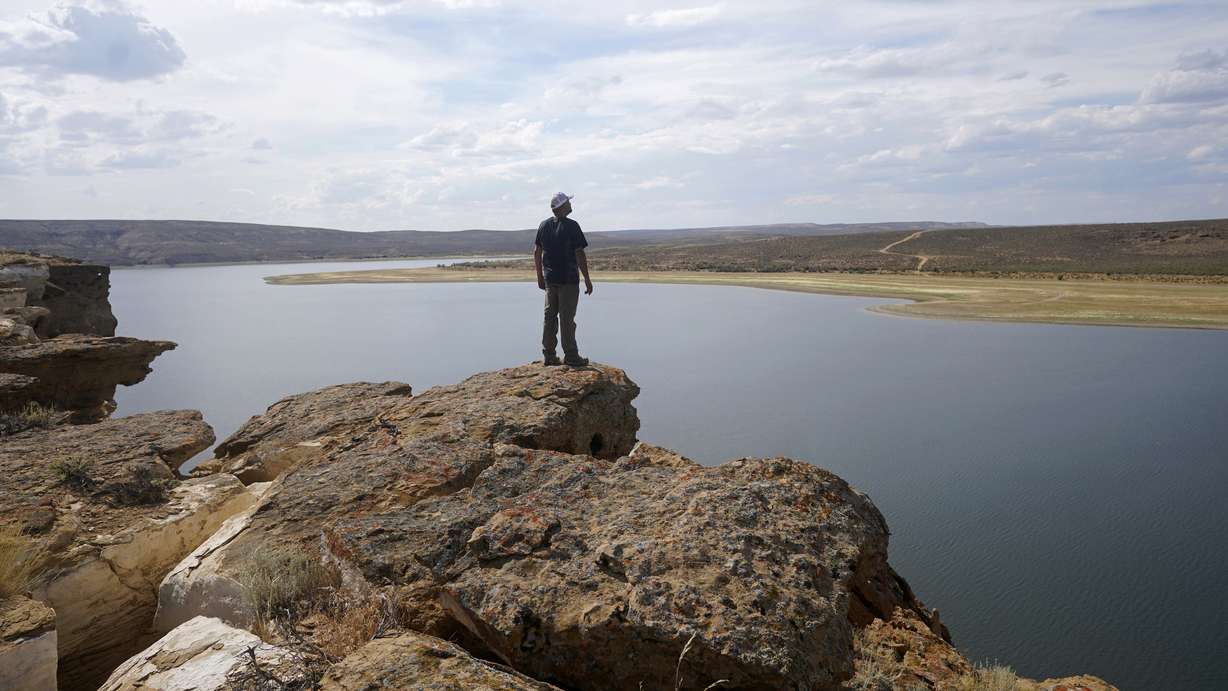 Tony Valdez, owner of Buckboard Marina, looks over Flaming Gorge Reservoir in southwestern Wyoming on Thursday, Aug. 4, 2022. A boating and fishing paradise on the Utah-Wyoming line, Flaming Gorge is beginning to feel the effects of the two-decade megadrought gripping the southwestern U.S.