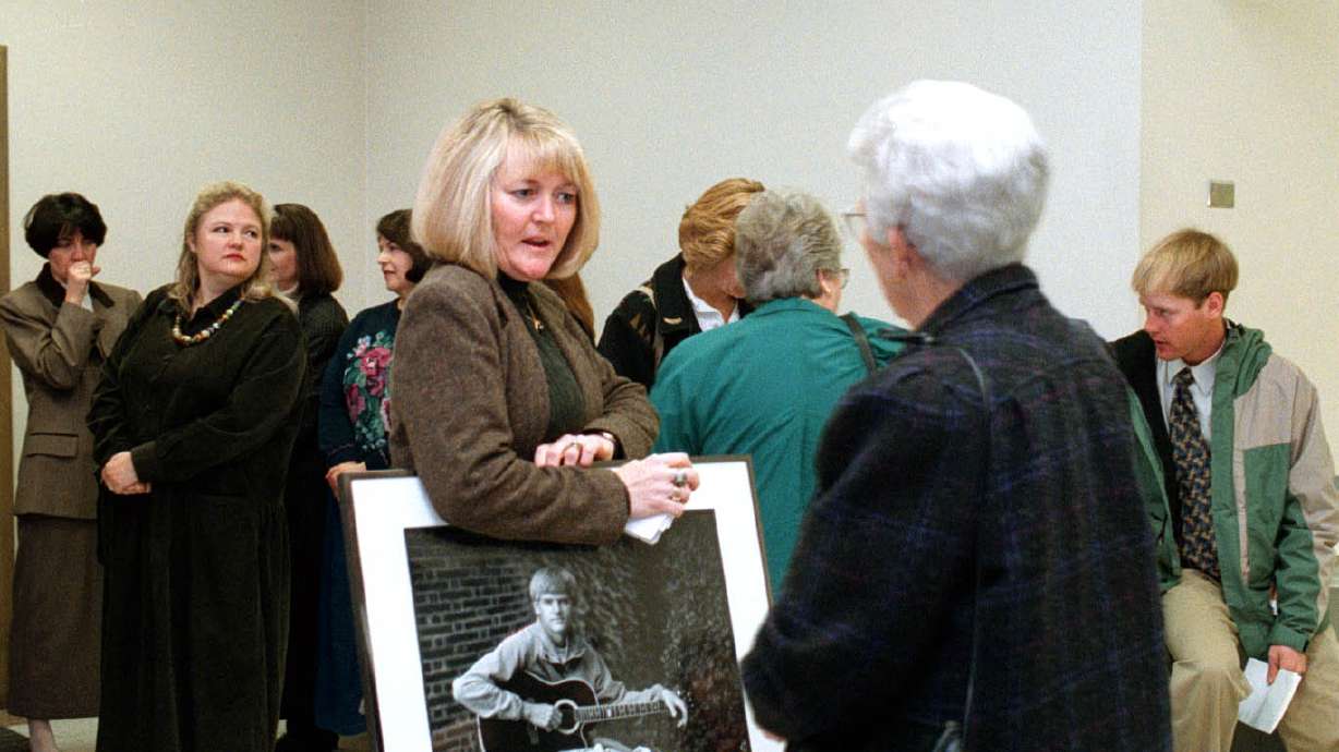 Family members gather outside a courtroom where Jorge Benvenuto was sentenced for murder on Jan. 30, 1998. Sy Snarr, Zach Snarr's mother, holds a large picture of her son. Episode 4 of "The Letter" podcast looks back at the sentencing hearing.