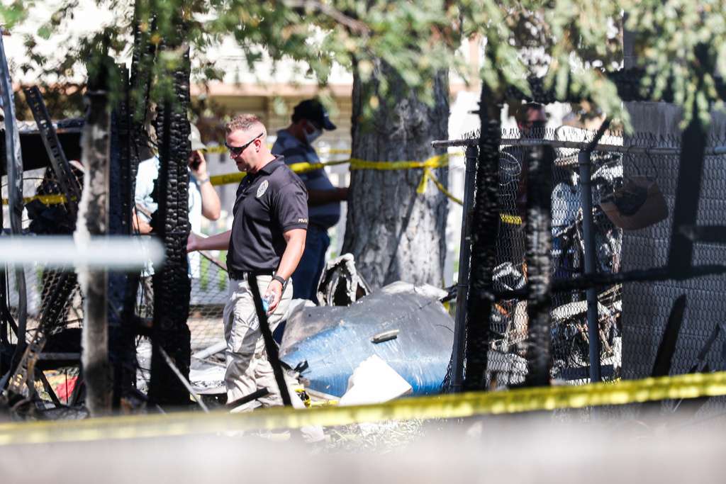 Police officers investigate a plane crash near Old Bingham Highway in West Jordan on July 25, 2020. National Transportation Safety Board officials on Friday released the results of an investigation of a 2020 plane crash in West Jordan that left four dead and injured two others.