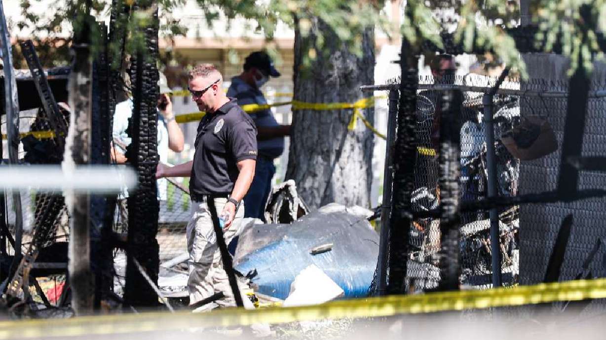 Police officers investigate a plane crash near Old Bingham Highway in West Jordan on July 25, 2020. National Transportation Safety Board officials on Friday released the results of an investigation of a 2020 plane crash in West Jordan that left four dead and injured two others.