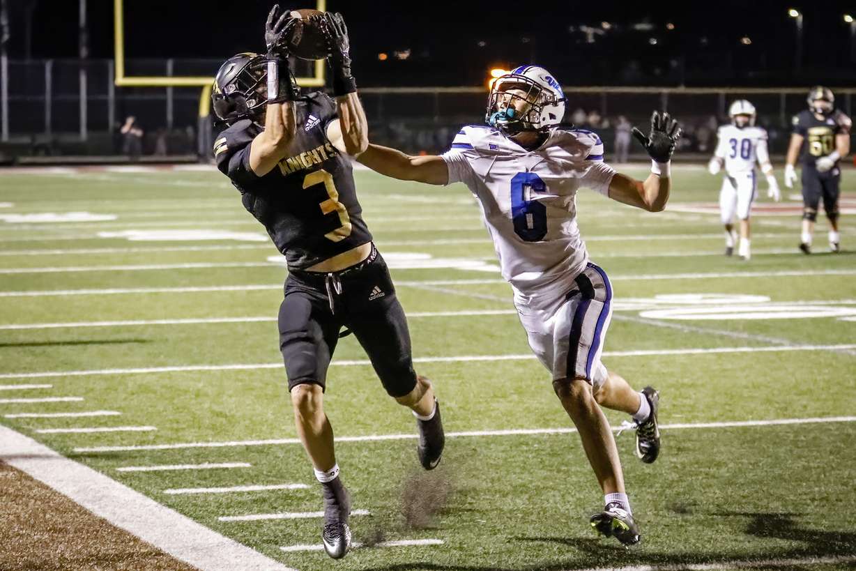 Lone Peak’s Crew McChesney (3) hauls in a pass along the sideline while Pleasant Grove’s Makai Peterson (6) defends as Lone Peak hosts Pleasant Grove in Highland, Utah on Friday, Sept. 16, 2022