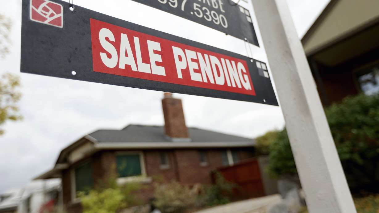 A “For Sale” sign and “Sale Pending” sign are pictured in Salt Lake City on Oct. 18, 2021. Nearly a third of all U.S. homes are being bought with all cash — and even though that trend has dipped slightly from earlier this year, it's still up from before the COVID-19 pandemic sent the housing market into a frenzy.