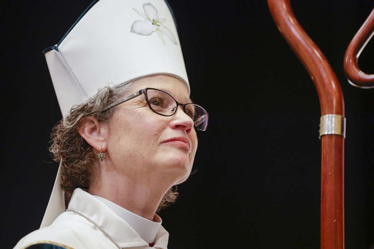 Phyllis Spiegel is ordained as a bishop and listens to prayer inside the Capitol Theatre in Salt Lake City on Saturday.