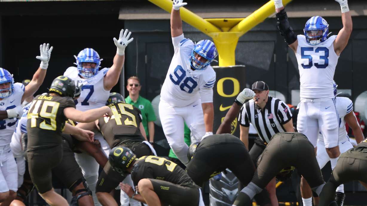 Brigham Young Cougars defenders try to block an extra point at Autzen Stadium in Eugene on Saturday, Sept. 17, 2022.