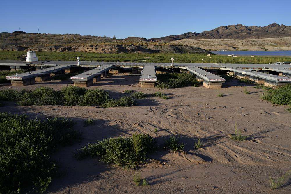 Floating boat docks sit on dry ground as water levels have declined near the Callville Bay Resort & Marina in the Lake Mead National Recreation Area, Aug. 30, near Boulder City, Nev. As America's large reservoirs on the Colorado River drop to record-low levels, fish are among those suffering the impact.