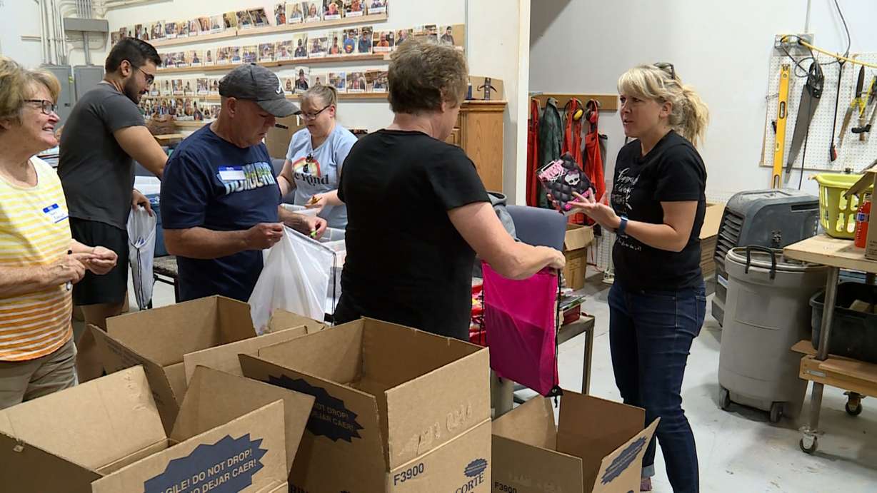 Emilee Johnson, right, discusses the types of books they should include in backpacks slated to be sent to Zimbabwe.