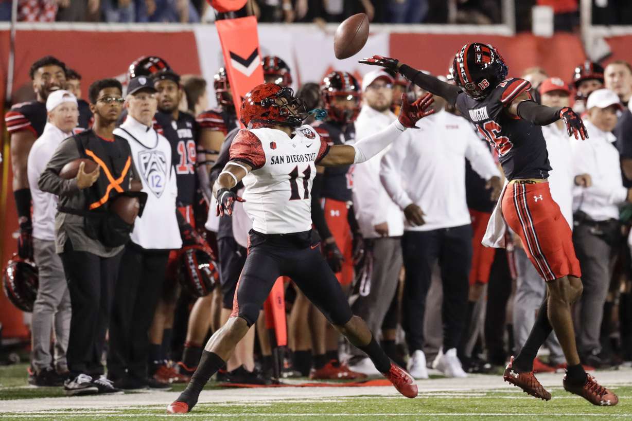 Brionne Penny (16) of the San Diego State Aztecs misses a pass as it was deflected by Zemaiah Vaughn (16) of the Utah Utes in Salt Lake City on Saturday, Sept. 17, 2022. The Utes won 35-7.