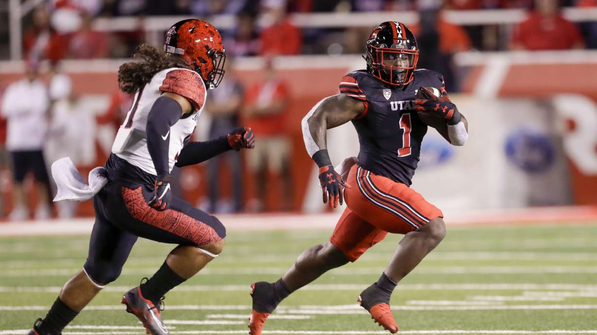 Jaylon Glover (1) of the Utah Utes runs away from Zyrus Fiaseun (51) of the San Diego State Aztecs in Salt Lake City on Saturday, Sept. 17, 2022. The Utes won 35-7.