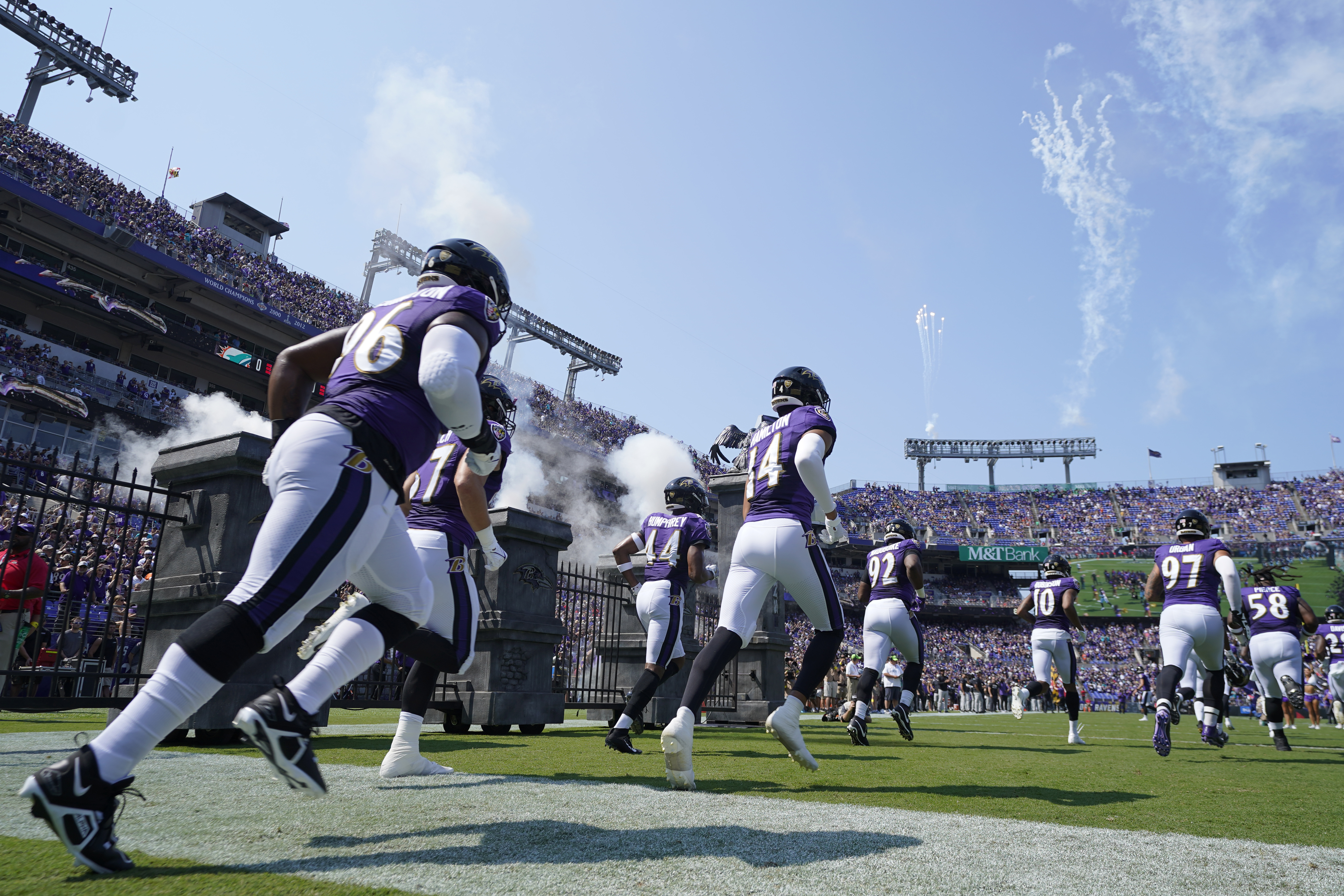 The Baltimore Ravens team enters the field during before an NFL football game against the Miami Dolphins, Sunday, Sept. 18, 2022, in Baltimore. 