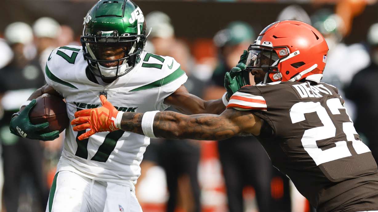 New York Jets wide receiver Garrett Wilson tries to break away from Cleveland Browns safety Grant Delpit (22) during the second half of an NFL football game, Sunday, Sept. 18, 2022, in Cleveland. The Jets won 31-30.
