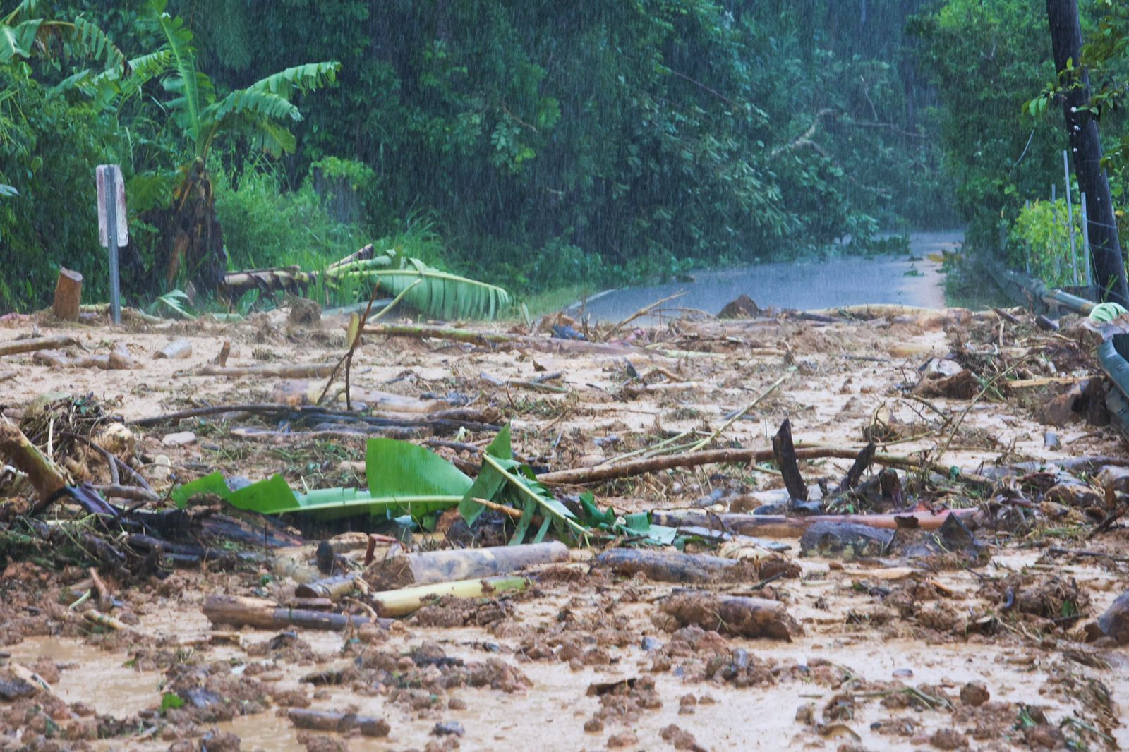 A road blocked is blocked by a mudslide caused by Hurricane Fiona in Cayey, Puerto Rico, Sunday.
