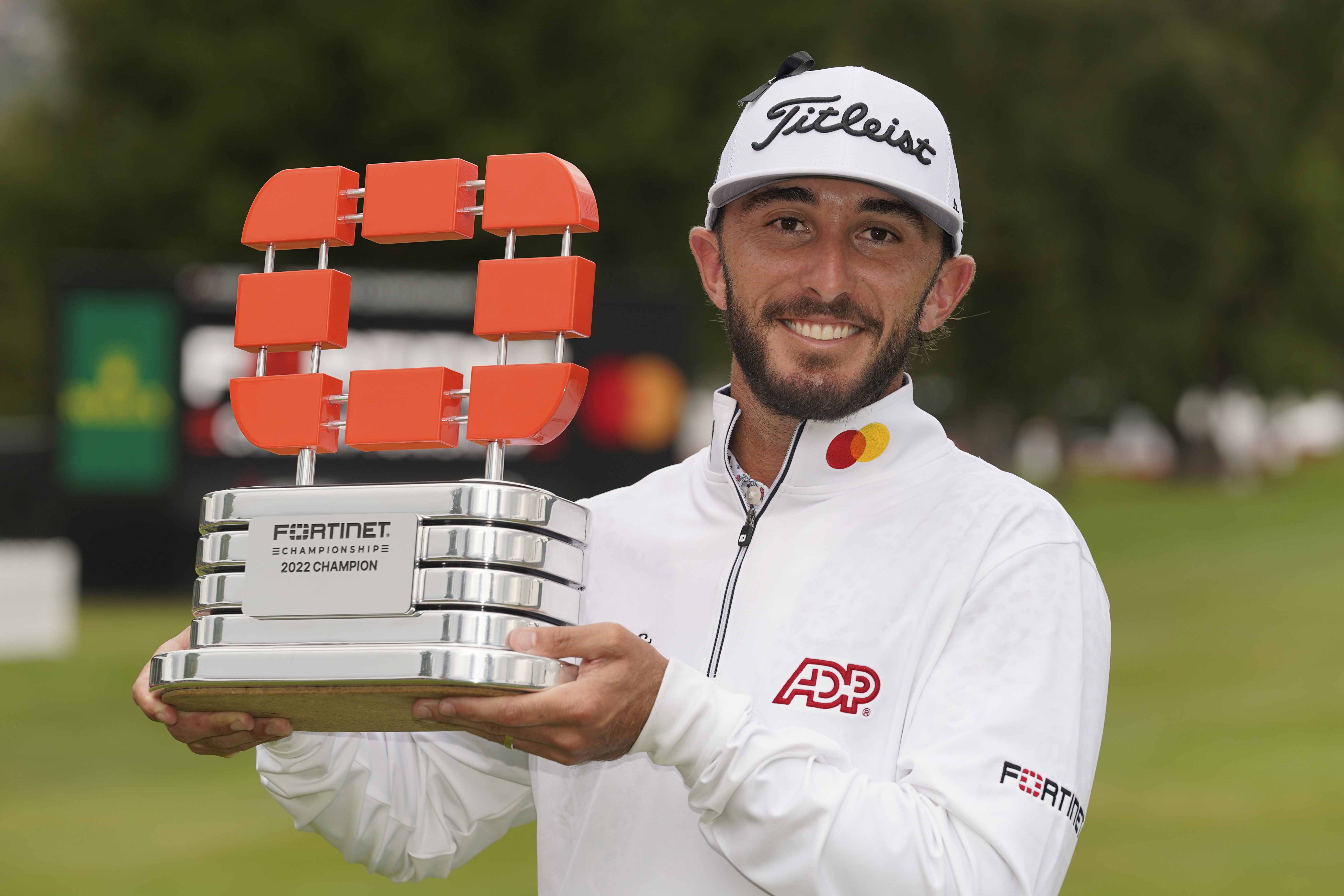 Max Homa poses with his trophy on the 18th green of the Silverado Resort North Course after winning the Fortinet Championship PGA golf tournament in Napa, Calif., Sunday, Sept. 18, 2022.