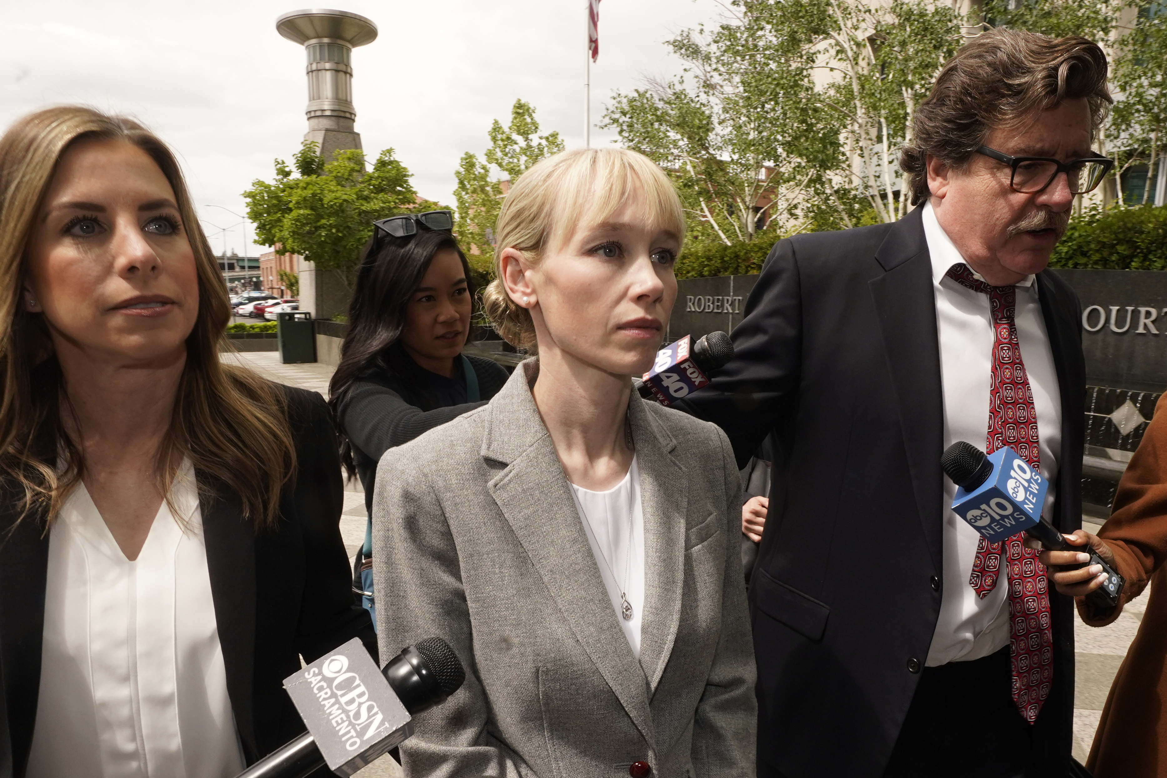 Sherri Papini of Redding walks to the federal courthouse accompanied by her attorney, William Portanova, right, in Sacramento, Calif., April 13. Papini is scheduled to appear in federal court, Monday, where prosecutors are asking that she be sentenced to eight months in prison for faking her own kidnapping in 2016. 