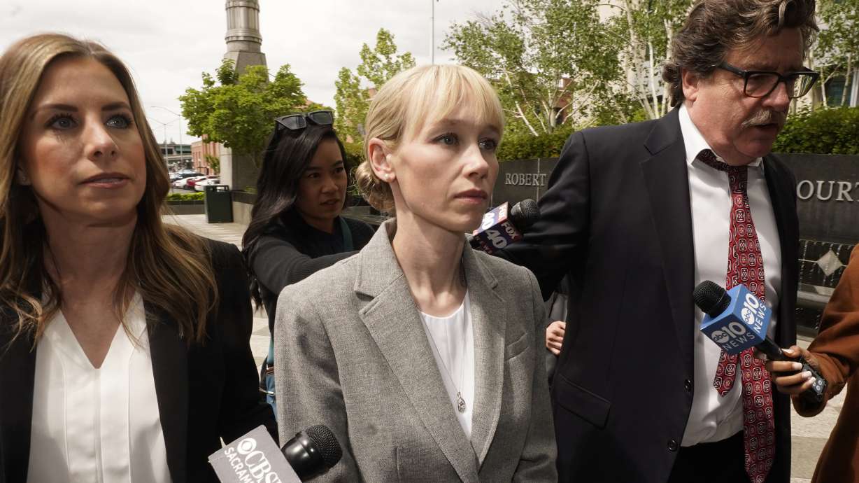 Sherri Papini of Redding walks to the federal courthouse accompanied by her attorney, William Portanova, right, in Sacramento, Calif., April 13. Papini is scheduled to appear in federal court, Monday, where prosecutors are asking that she be sentenced to eight months in prison for faking her own kidnapping in 2016.