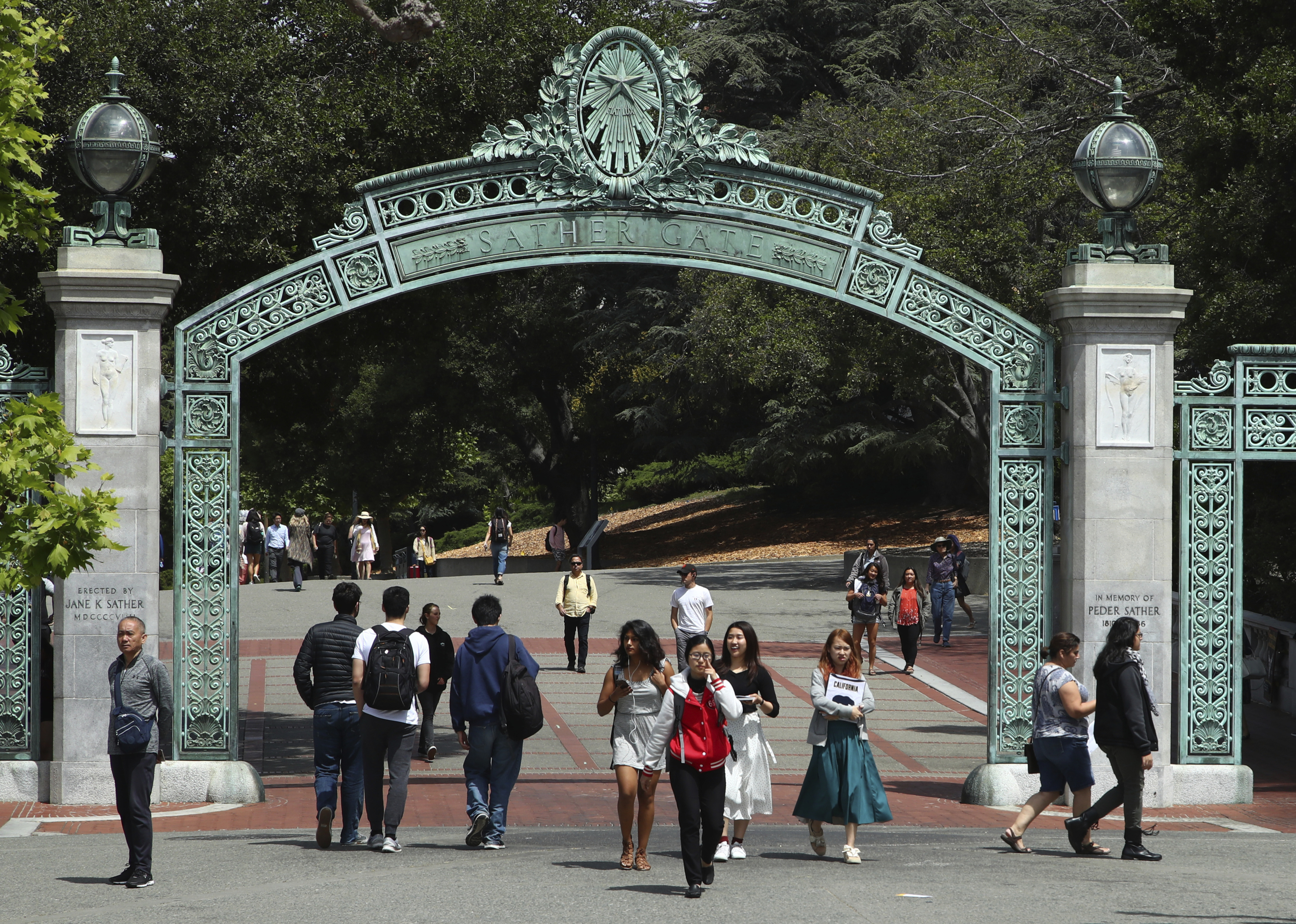 Students walk past Sather Gate on the University of California at Berkeley campus on May 10, 2018, in Berkeley, Calif. President Joe Biden's student loan forgiveness plan, announced in August, could lift crushing debt burdens from millions of borrowers. However, the tax man may demand a cut of the relief in some states, as some states tax forgiven debt as income.