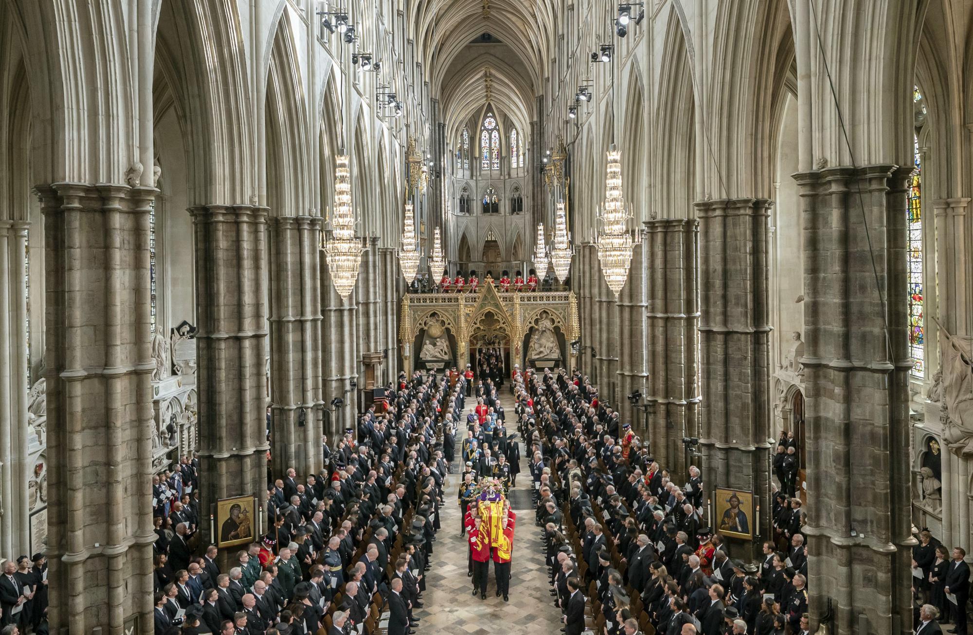 King Charles III, Camilla, the Queen Consort and members of the Royal family follow behind the coffin of Queen Elizabeth II, draped in the Royal Standard with the Imperial State Crown and the Sovereign's orb and sceptre, as it is carried out of Westminster Abbey after her State Funeral, in London, Monday. The Queen, who died aged 96 on Sept. 8, will be buried at Windsor alongside her late husband, Prince Philip, who died last year.