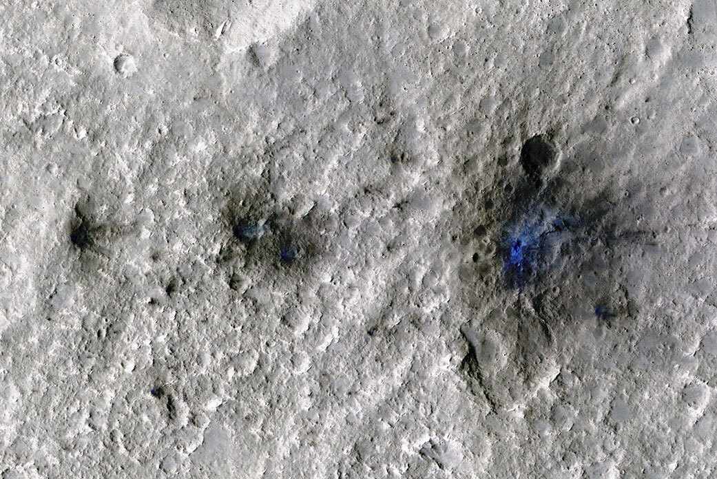 This undated photo released by NASA shows craters that were formed by a Sept. 5, 2021, meteoroid impact on Mars, the first to be detected by NASA’s InSight. NASA’s Mars Reconnaissance Orbiter has captured the vibrations and sounds of four meteorites striking the planet's surface. Scientists reported Monday that Mars InSight detected seismic and acoustic waves from a series of impacts in 2020 and 2021. 