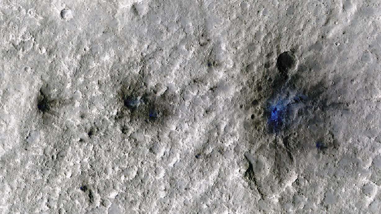 This undated photo released by NASA shows craters that were formed by a Sept. 5, 2021, meteoroid impact on Mars, the first to be detected by NASA’s InSight. NASA’s Mars Reconnaissance Orbiter has captured the vibrations and sounds of four meteorites striking the planet's surface. Scientists reported Monday that Mars InSight detected seismic and acoustic waves from a series of impacts in 2020 and 2021.