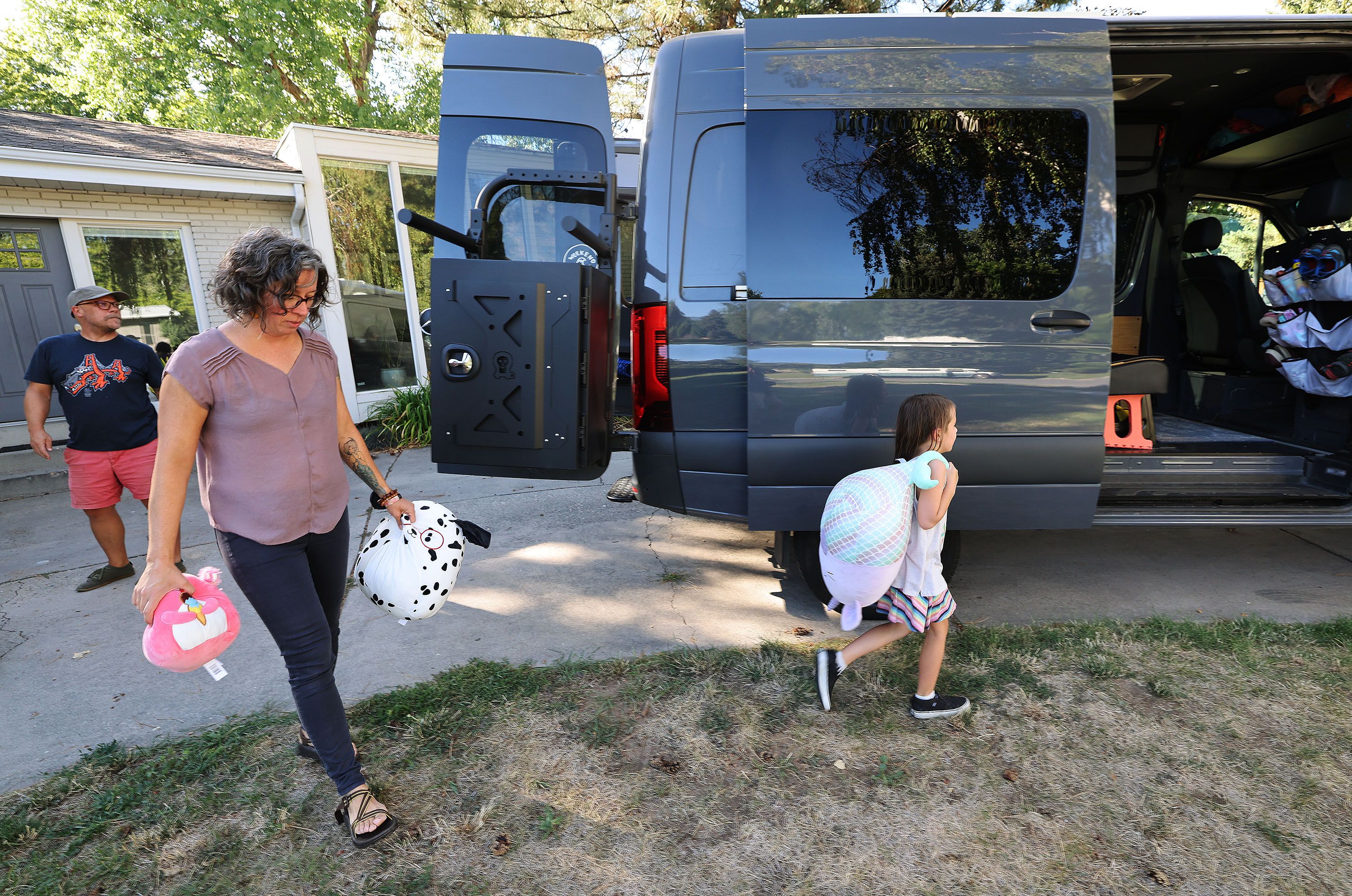 Jason and Deb Miller pack for a family road trip with one of their daughters, Teagan, 8, at their home in Murray on Sept. 2.