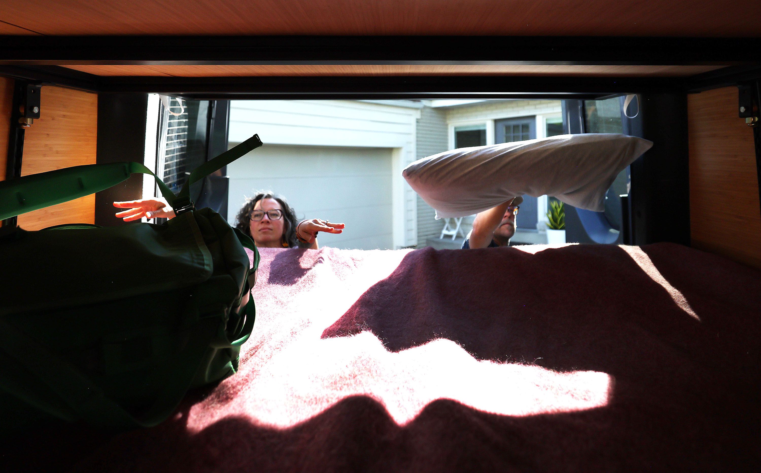 Jason and Deb Miller load items into a van as they pack for a family road trip at their home in Murray on Sept. 2.
