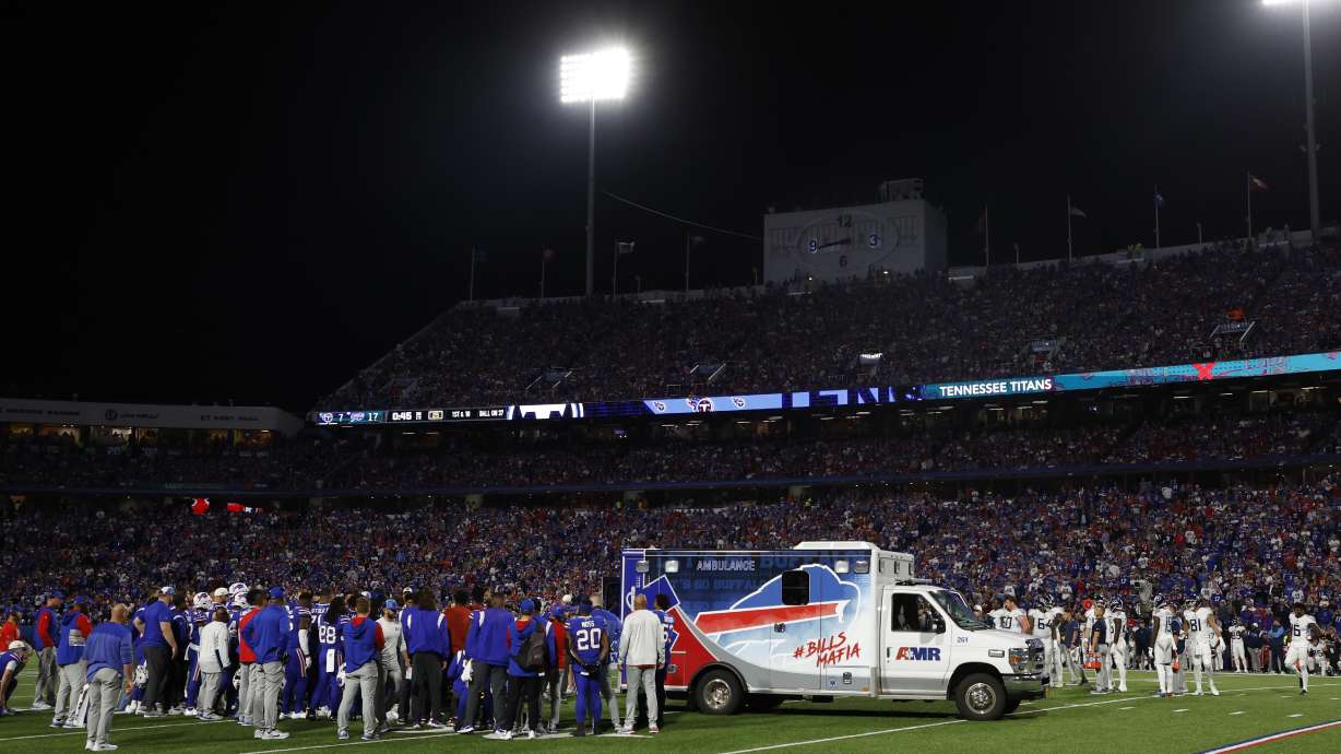 Players gather around an ambulance on the field after an injury to Buffalo Bills' Dane Jackson during the first half of an NFL football game against the Tennessee Titans, Monday, Sept. 19, 2022, in Orchard Park, N.Y.