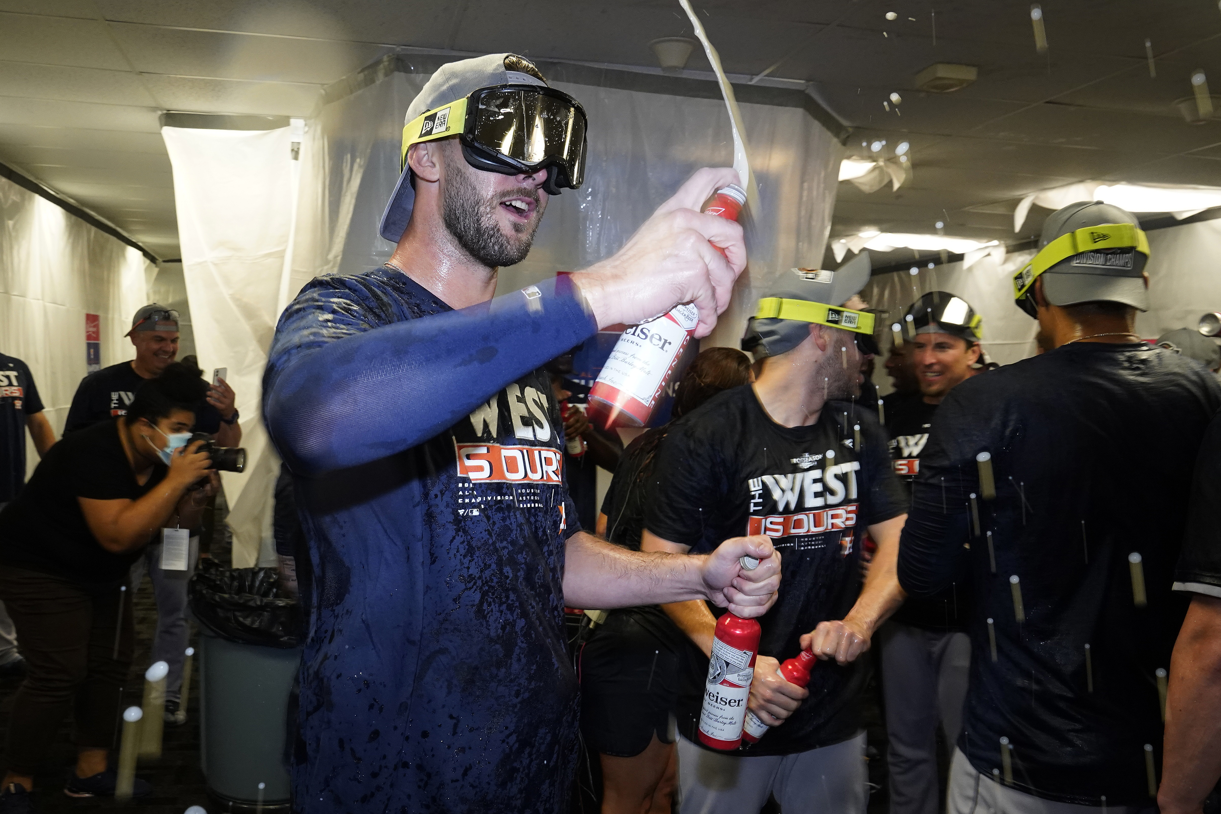Houston Astros players celebrate in the clubhouse after clinching the American League West title with a win over the Tampa Bay Rays during a baseball game Monday, Sept. 19, 2022, in St. Petersburg, Fla.