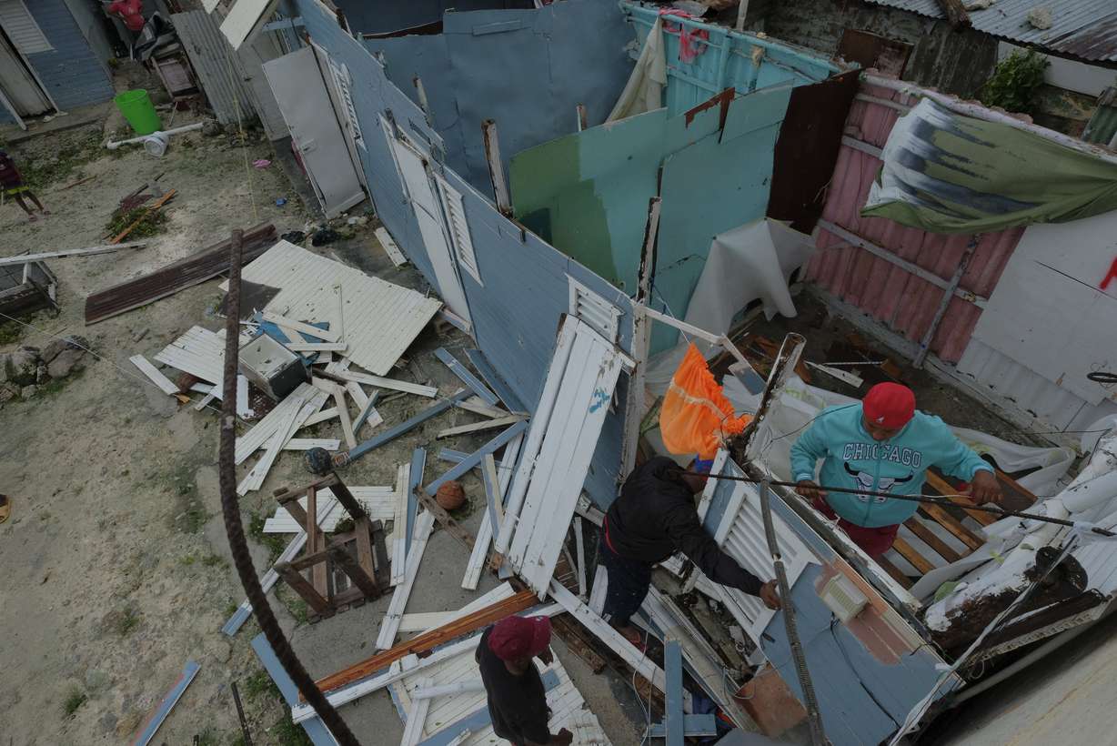 Residents replace a home's roof that was torn off by Hurricane Fiona in the low-income neighborhood of Kosovo in Veron de Punta Cana, Dominican Republic, Monday.