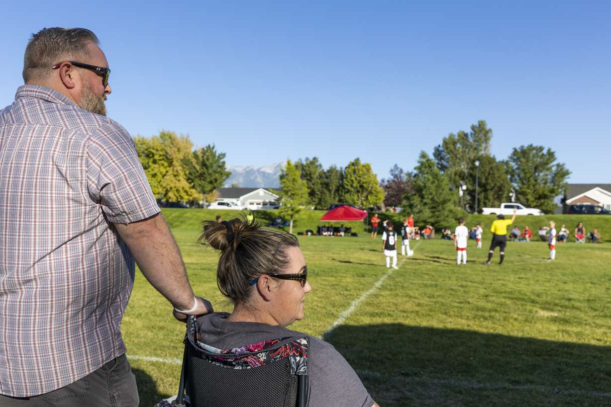 Jeremy Homme rests his hand on his wife Michalene’s shoulder as they watch their son, Gage, 8, of the Utah Glory play the Cottonwood Football Club in South Jordan on Monday.