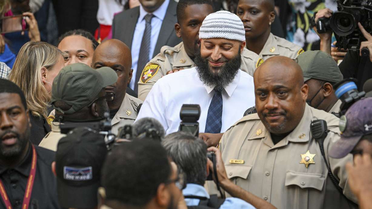 Adnan Syed, center, the man whose legal saga spawned the hit podcast "Serial," exits the Cummings Courthouse a free man after a Baltimore judge overturned his conviction for the 1999 murder of high school student Hae Min Lee, Monday, in Baltimore.