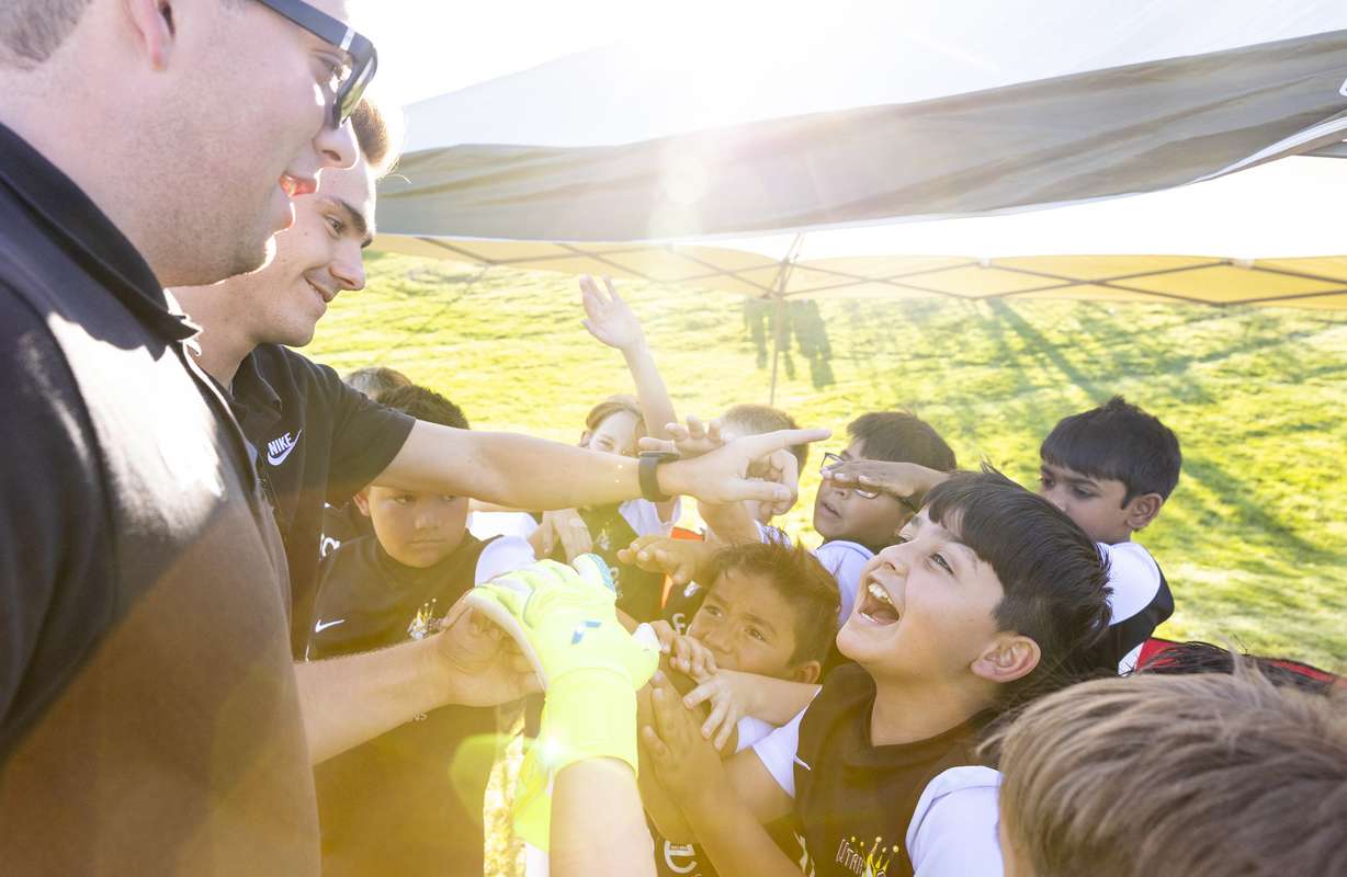 The Utah Glory huddle up before playing the Cottonwood Football Club in South Jordan on Monday.