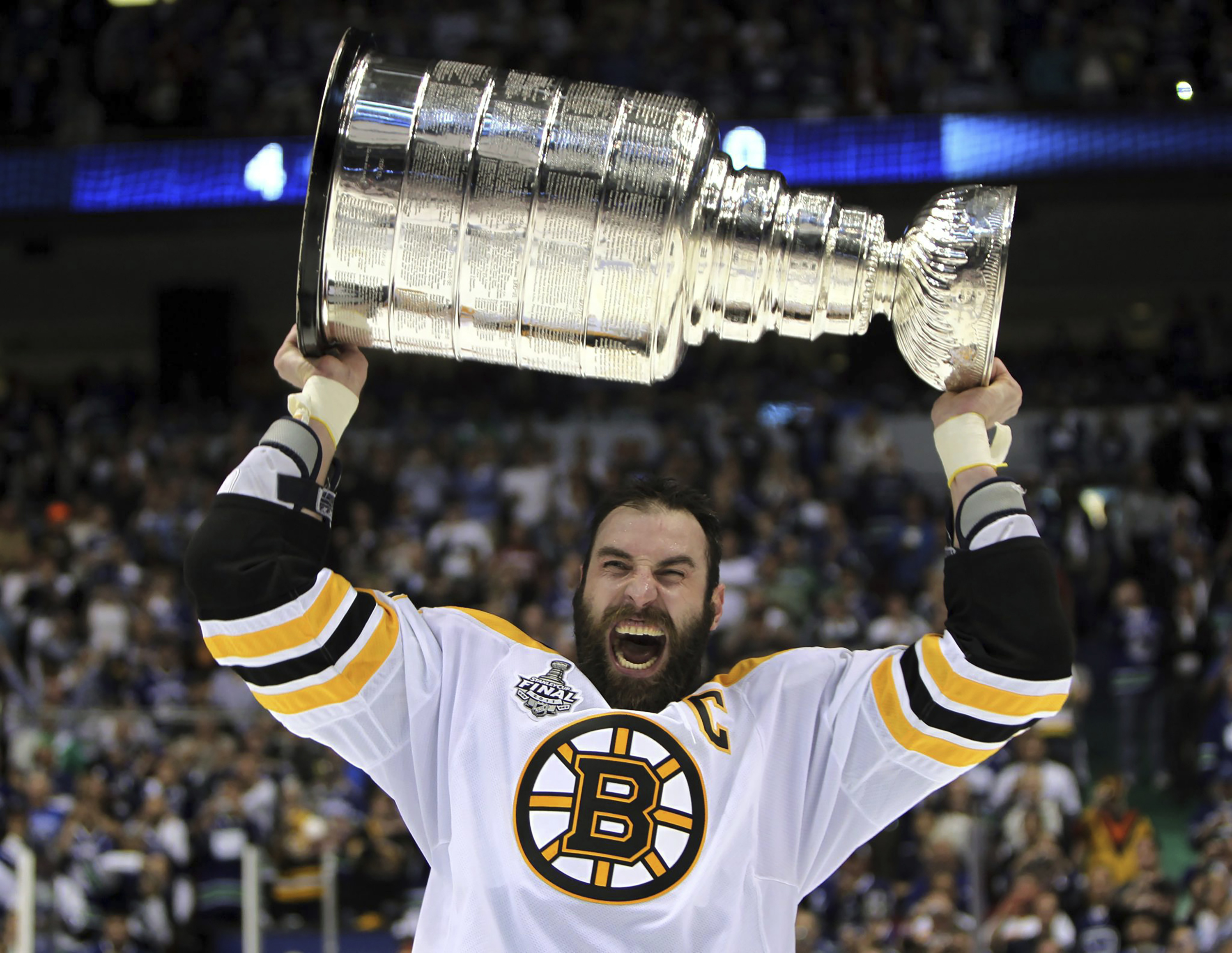 FILE - Boston Bruins' Zdeno Chara, of Slovakia, hoists the cup following the Bruins' 4-0 win over the Vancouver Canucks in Game 7 of the NHL hockey Stanley Cup Finals on Wednesday, June 15, 2011, in Vancouver, British Columbia. Chara announced his retirement Tuesday, Sept. 20, 2022, after playing 21 NHL seasons and captaining the Boston Bruins to the Stanley Cup in 2011. 