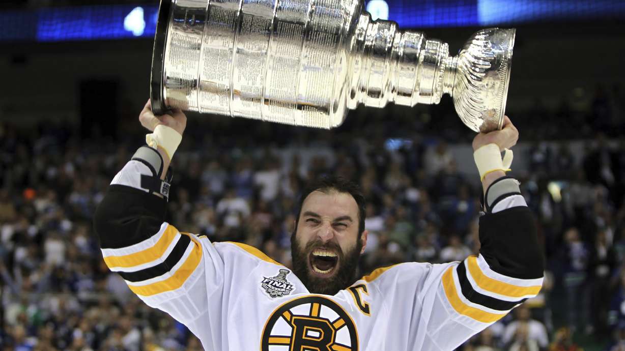 FILE - Boston Bruins' Zdeno Chara, of Slovakia, hoists the cup following the Bruins' 4-0 win over the Vancouver Canucks in Game 7 of the NHL hockey Stanley Cup Finals on Wednesday, June 15, 2011, in Vancouver, British Columbia. Chara announced his retirement Tuesday, Sept. 20, 2022, after playing 21 NHL seasons and captaining the Boston Bruins to the Stanley Cup in 2011.