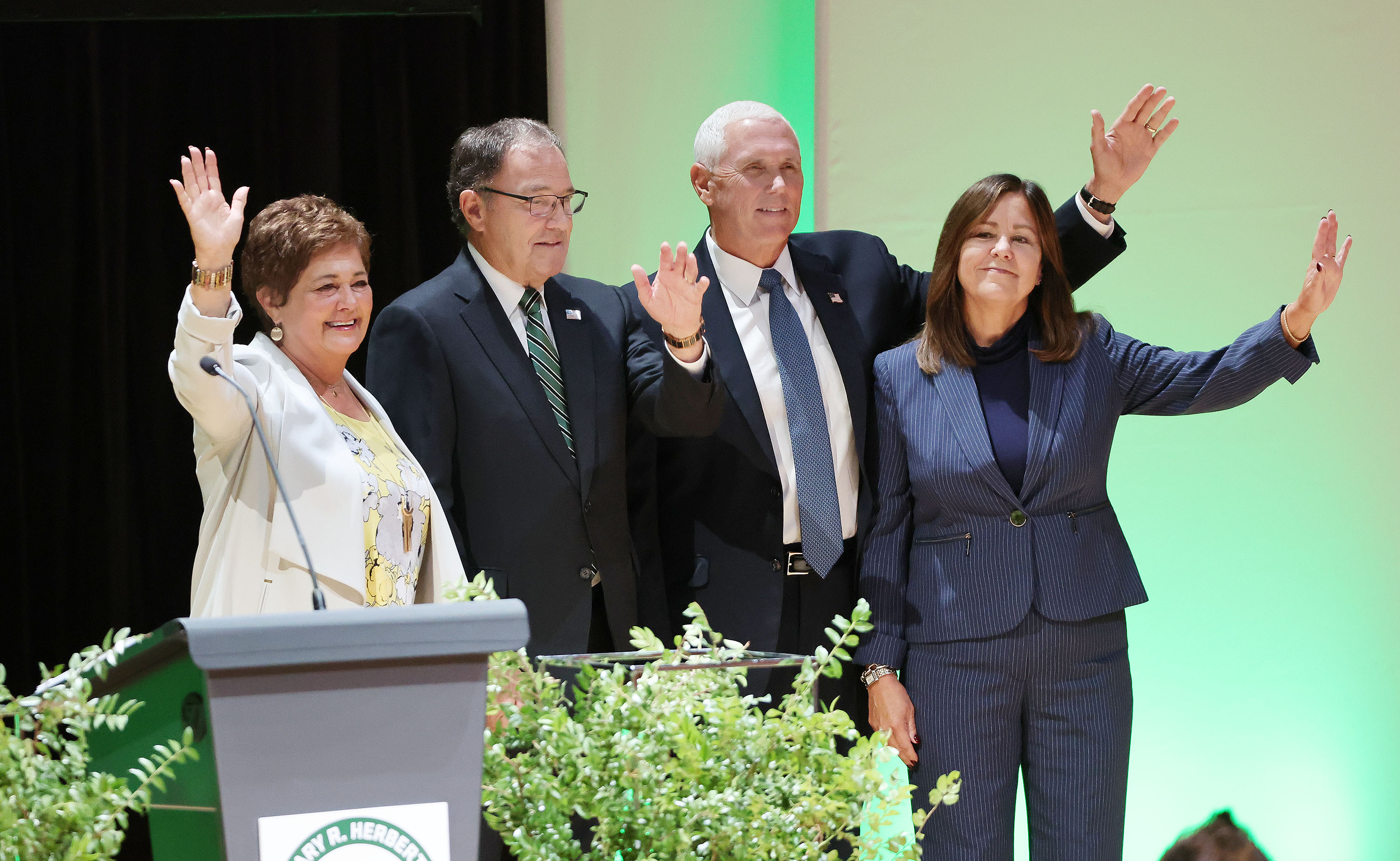 Former Vice President Mike Pence and wife Karen Pence, and former Utah Gov. Gary Herbert and wife Jeanette Herbert wave to attendees at Utah Valley University in Orem on Tuesday. Pence visited the Beehive State to speak to a packed audience at Utah Valley University's Gary R. Herbert Institute for Public Policy Fall Forum.
