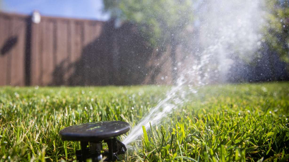 Sprinklers water a lawn in Salt Lake City on May 7, 2021. Salt Lake City's public utilities' executive director says the department has reduced water consumption by about 15% this year.