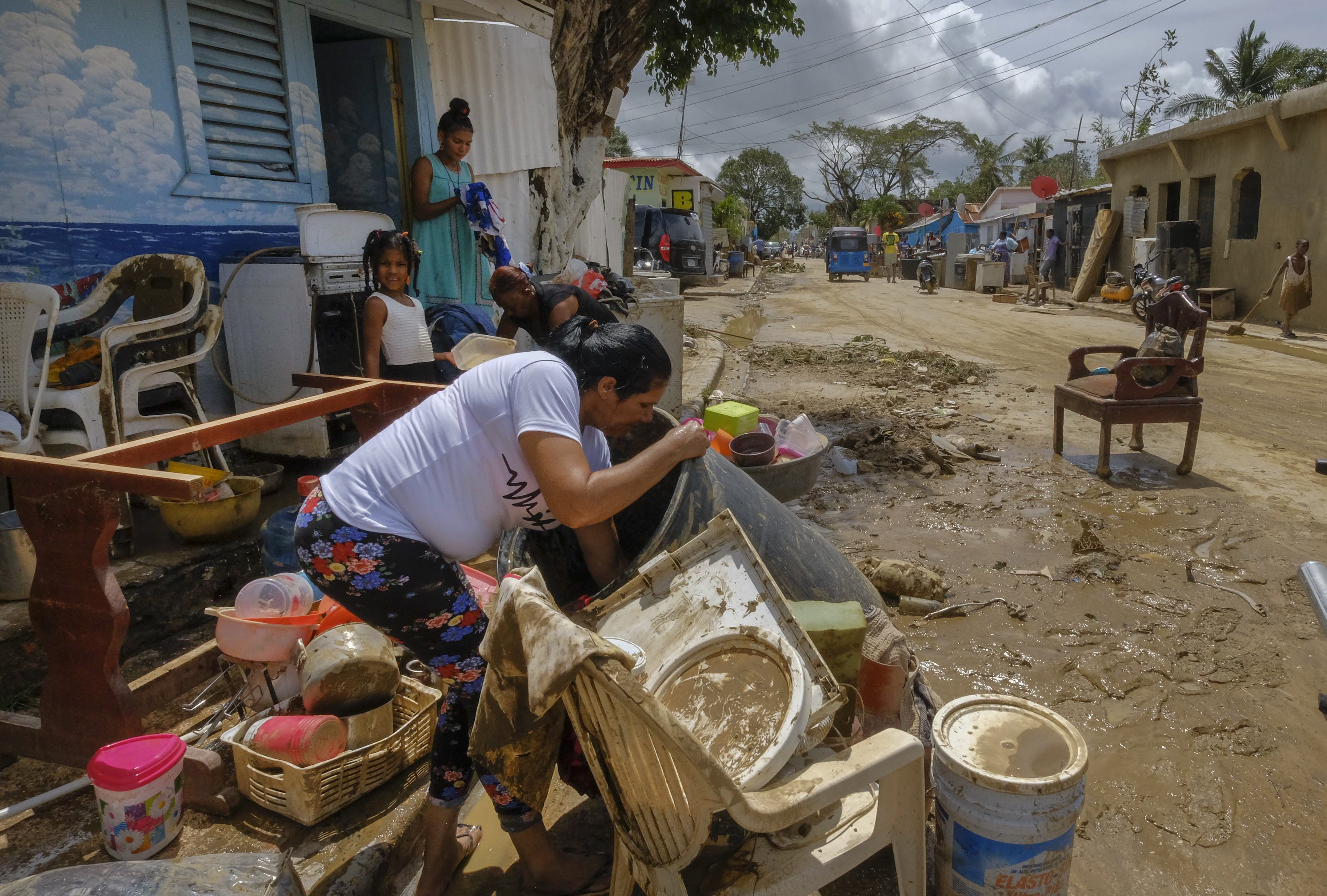 Residents work to recover belongings from flooding caused by Hurricane Fiona in the Los Sotos neighborhood of Higuey, Dominican Republic, Tuesday.