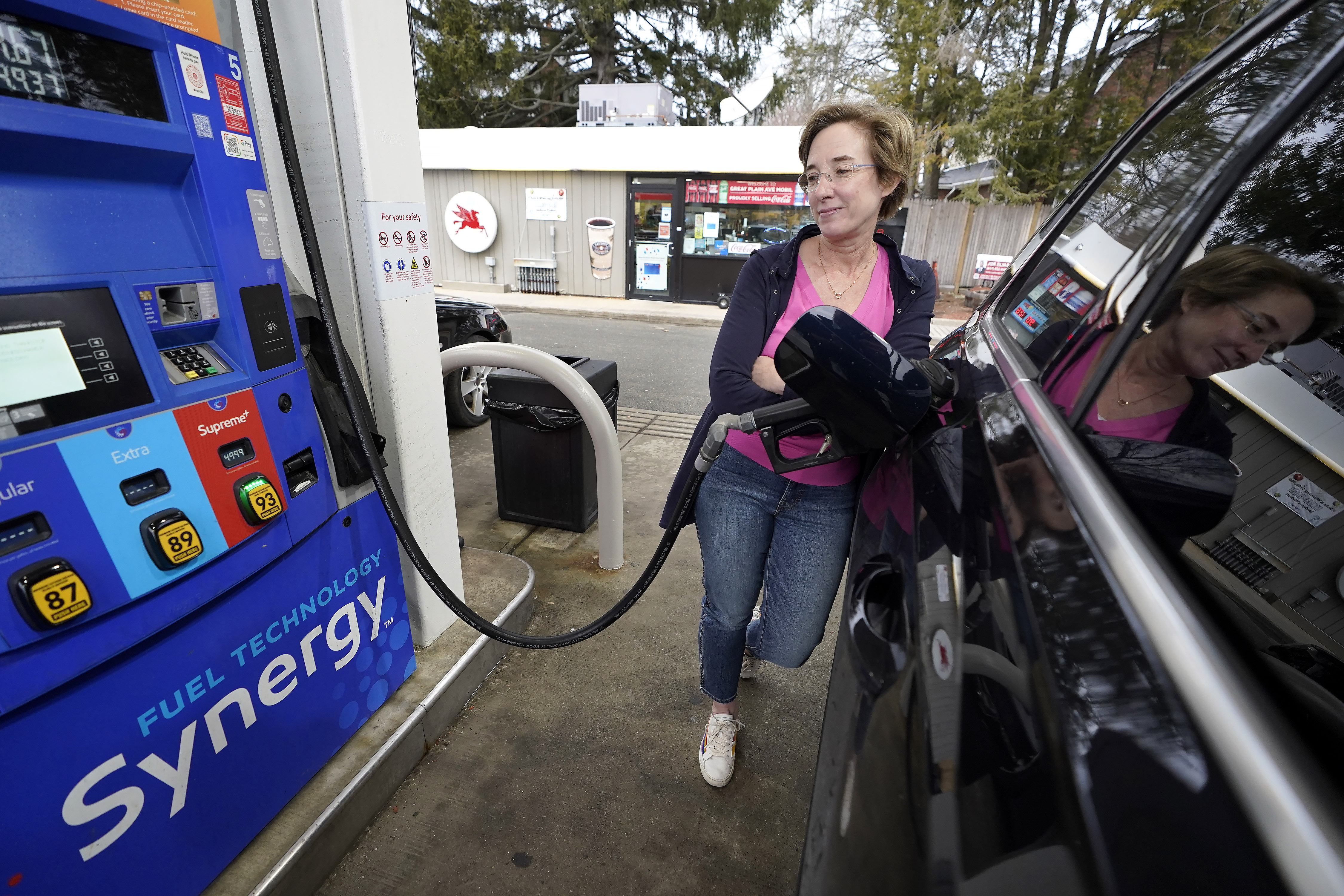 Jennifer Quinn fills her SUV at a gas station March 7, in Needham, Mass. The average price of regular gasoline nationwide is up slightly Wednesday, from a day earlier, the first time prices have climbed in 99 days.