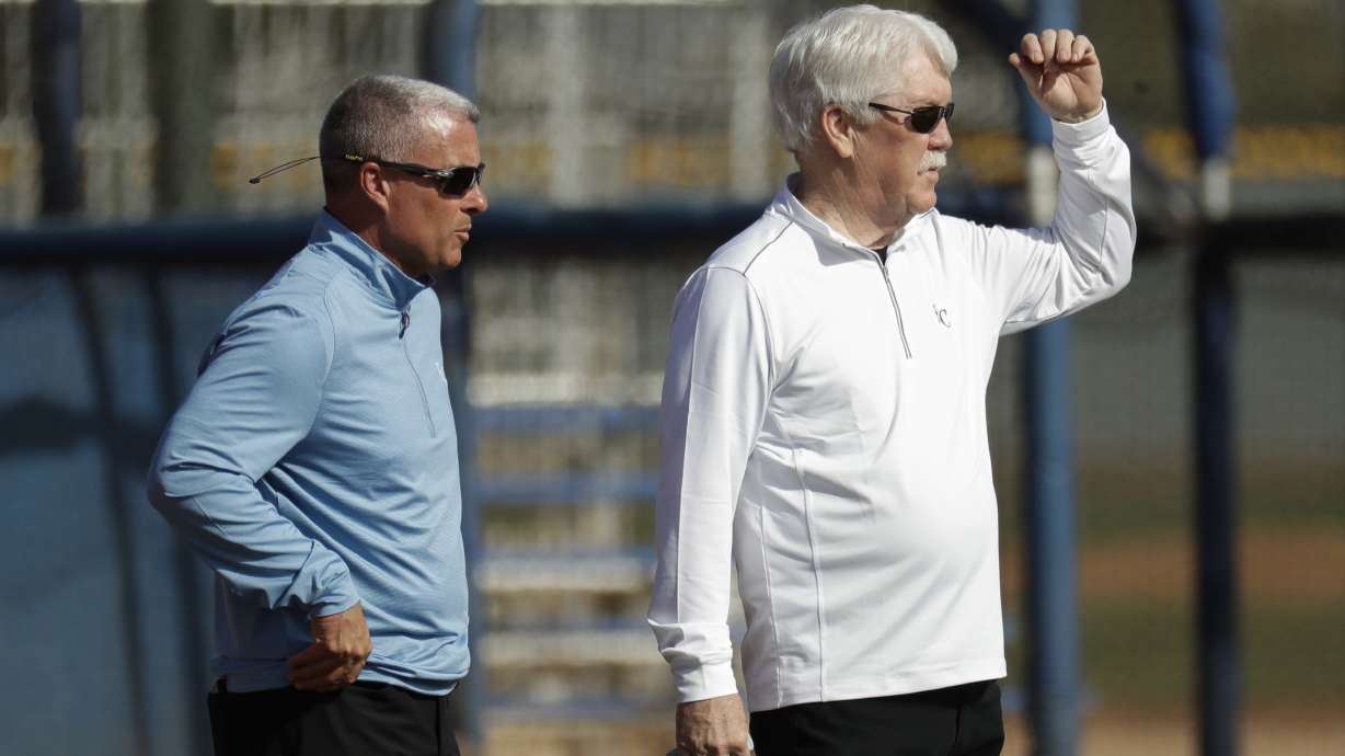 FILE - Kansas City Royals general manager Dayton Moore, left, and owner John Sherman watch a drill during spring training baseball practice Wednesday, Feb. 19, 2020, in Surprise, Ariz. The Kansas City Royals, Wednesday, Sept. 21, 2022, fired longtime general manager Dayton Moore. Royals owner John Sherman, who had retained Moore after acquiring the club from David Glass in 2019, announced the decision in a news conference that Moore attended at Kauffman Stadium on Wednesday.