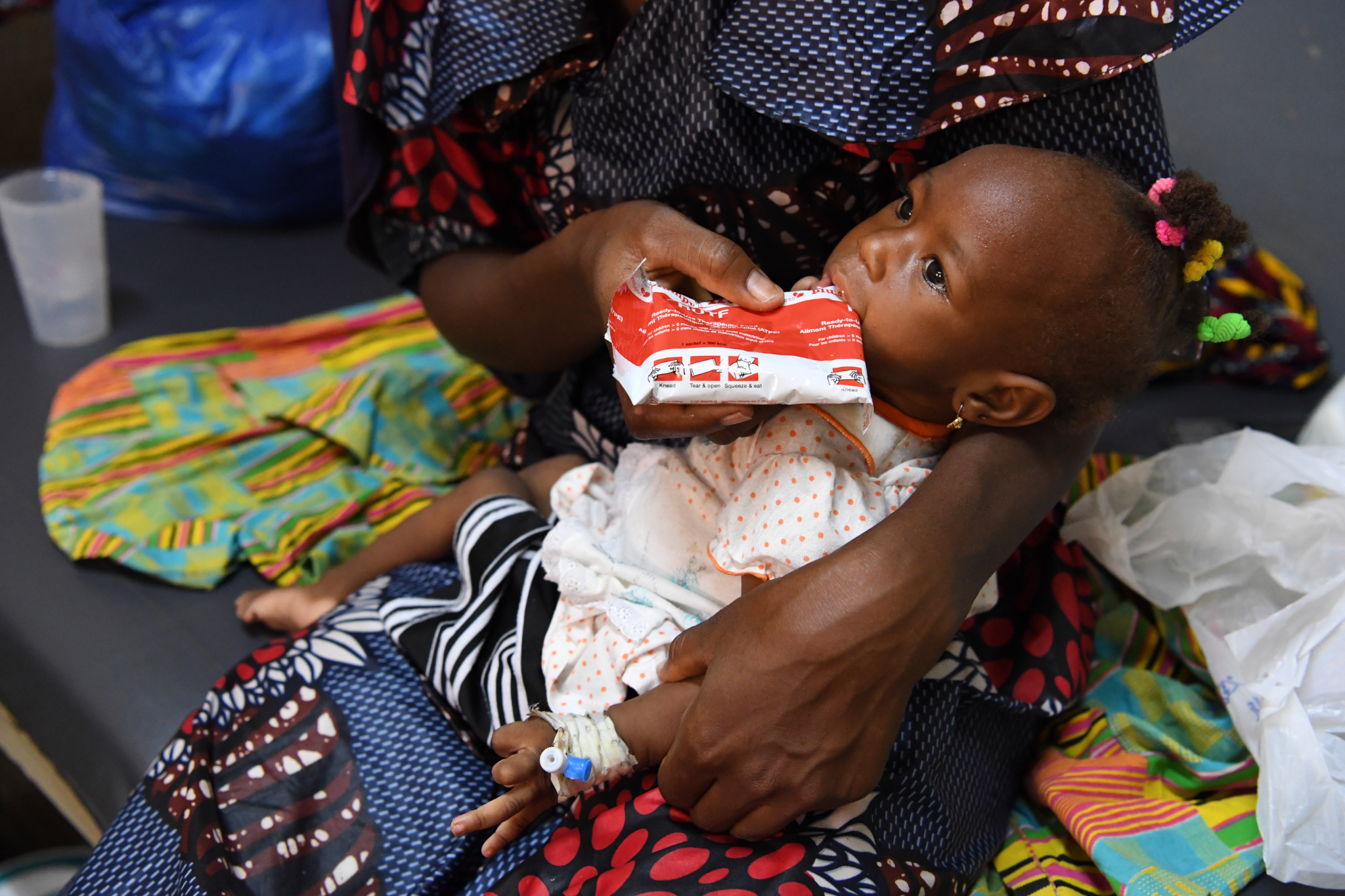 Konata, a 24-year-old mother of two children, with her 12-month-old daughter Mariam, at the Health Center of Bobo-Dioulasso, in the Southwestern region of Burkina Faso. Mariam is malnourished and was able to be given treatment and supplements.