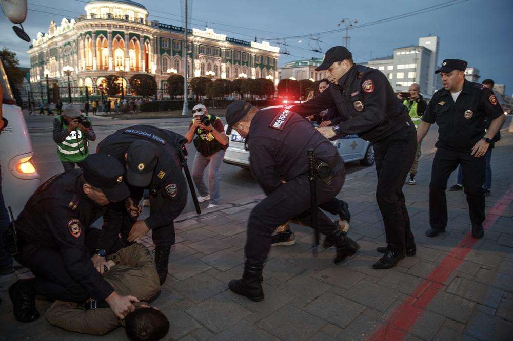 Police detain demonstrators during a protest against mobilization in Yekaterinburg, Russia, Wednesday. Russian President Vladimir Putin has ordered a partial mobilization of reservists in Russia, effective immediately.