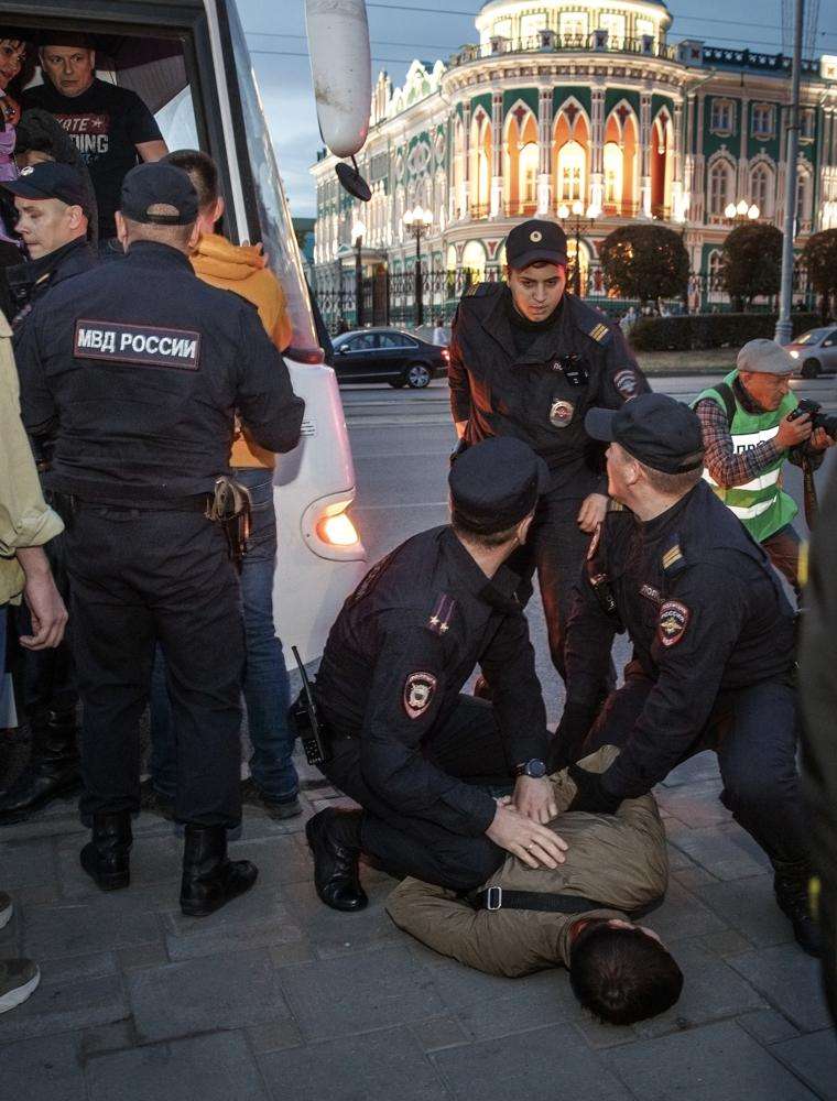 Police detain a demonstrator during a protest against mobilization in Yekaterinburg, Russia, Wednesday. Russian President Vladimir Putin has ordered a partial mobilization of reservists in Russia, effective immediately.